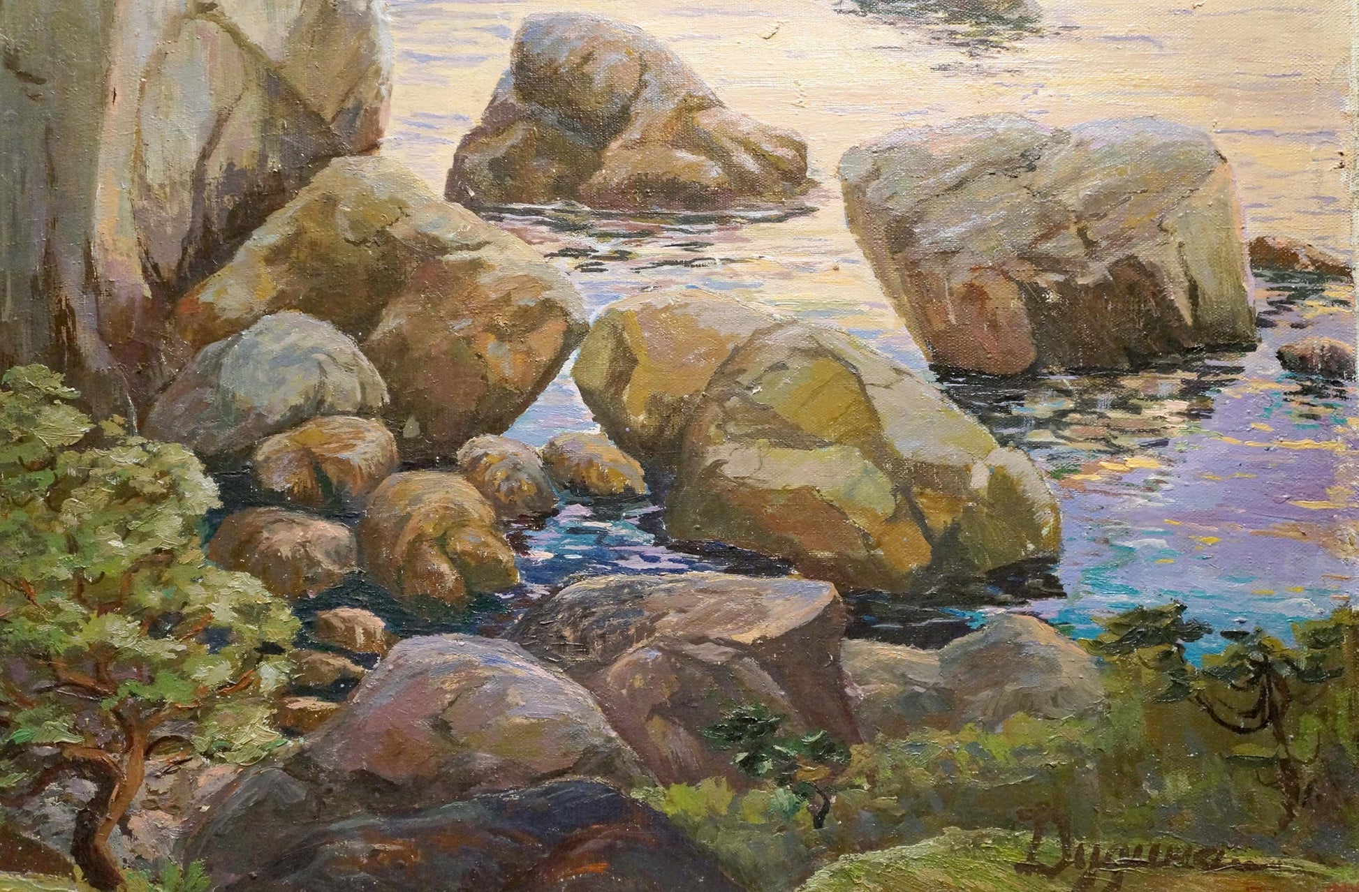 Oil painting of rugged sunlit coastal rocks with foliage and water
