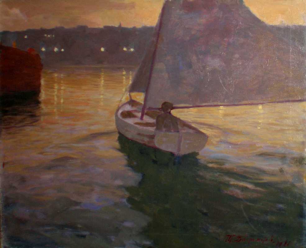 A small white sailboat with a dark sail glides across golden water at dusk, its silhouette framed by distant city lights.