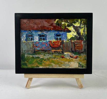 Oil painting Evening has come by Oksana Ivanyuk: vibrant blue house with red roof