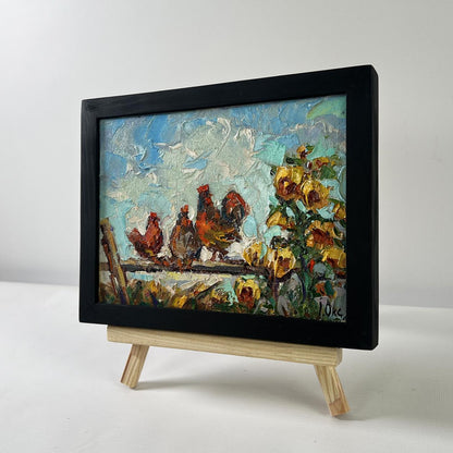Oil painting Morning rooster crowing by Oksana Ivanyuk in black frame on easel