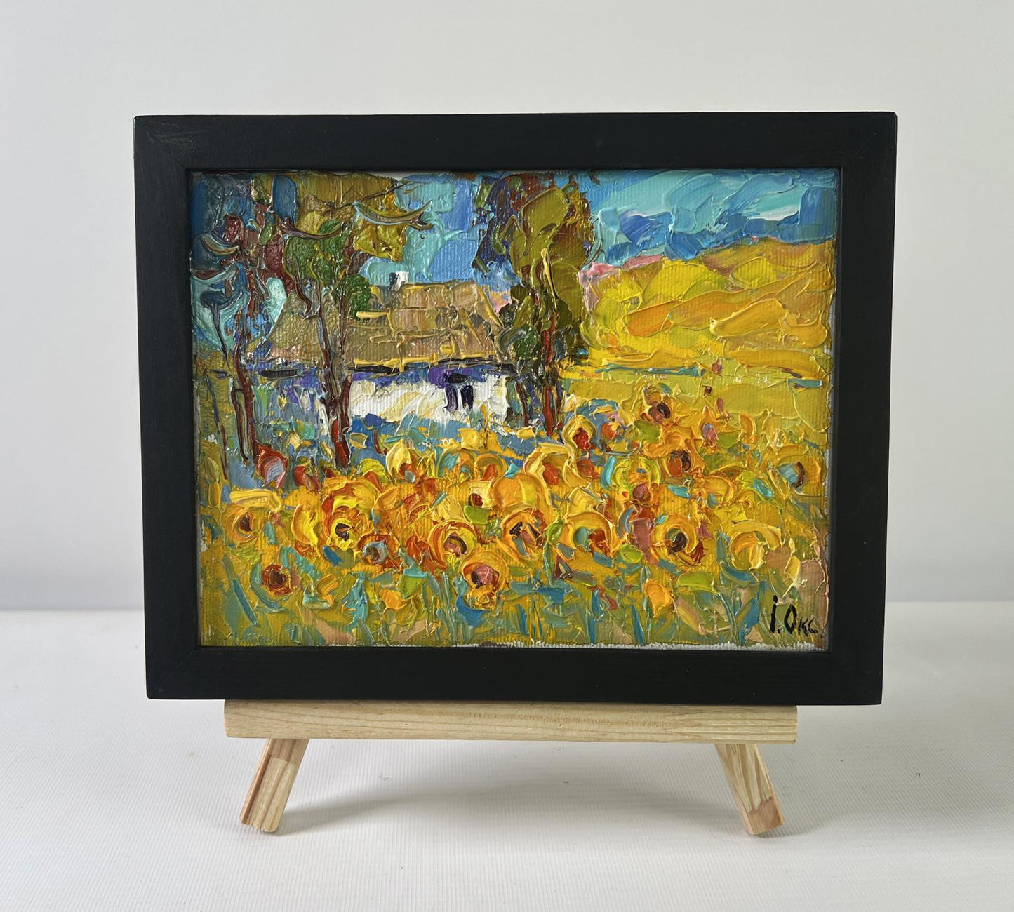 Oil painting of lush sunny sunflower fields by Oksana Ivanyuk on easel
