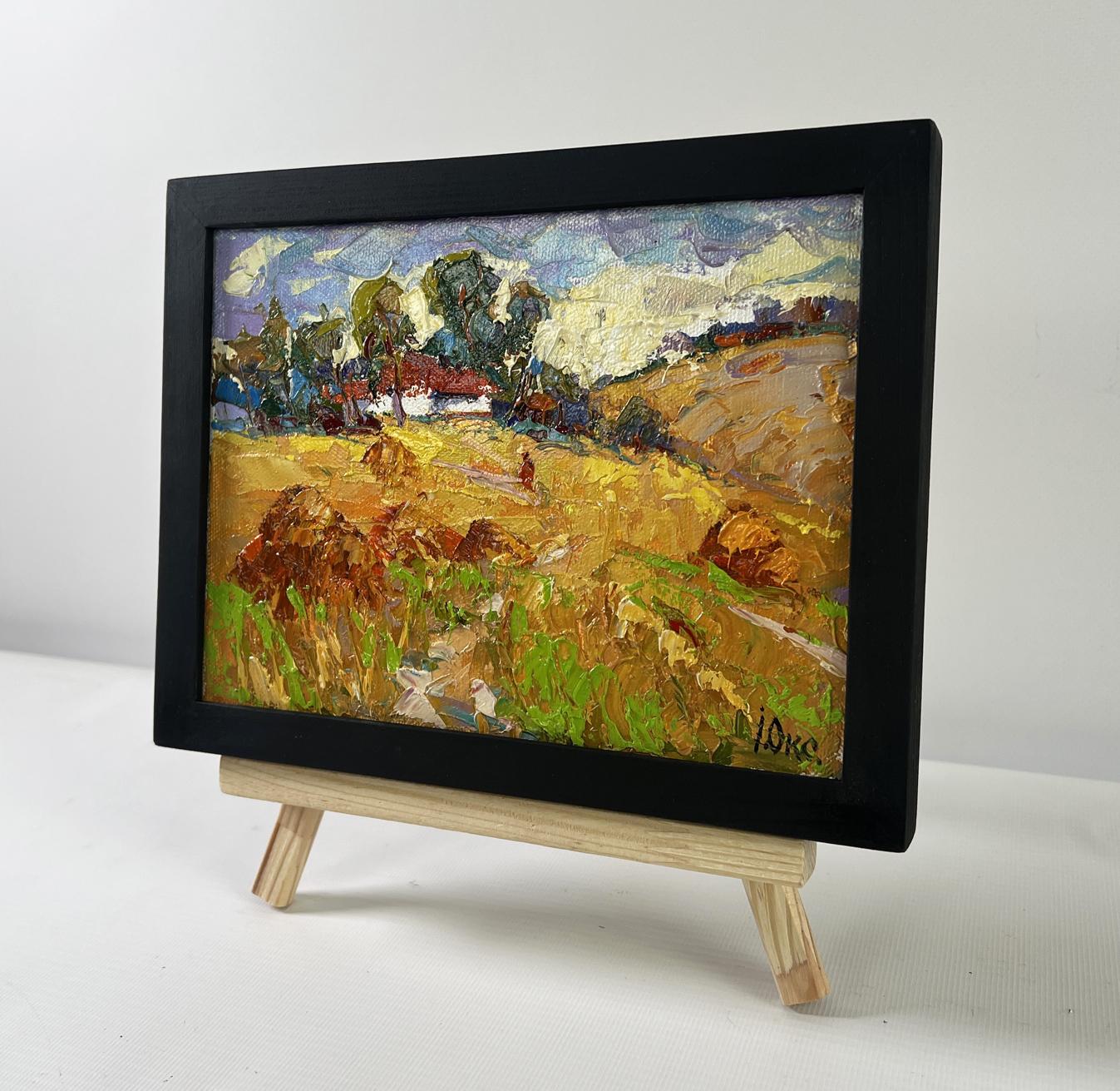 Oil painting Edge of the village by Oksana Ivanyuk, black-framed golden field scene