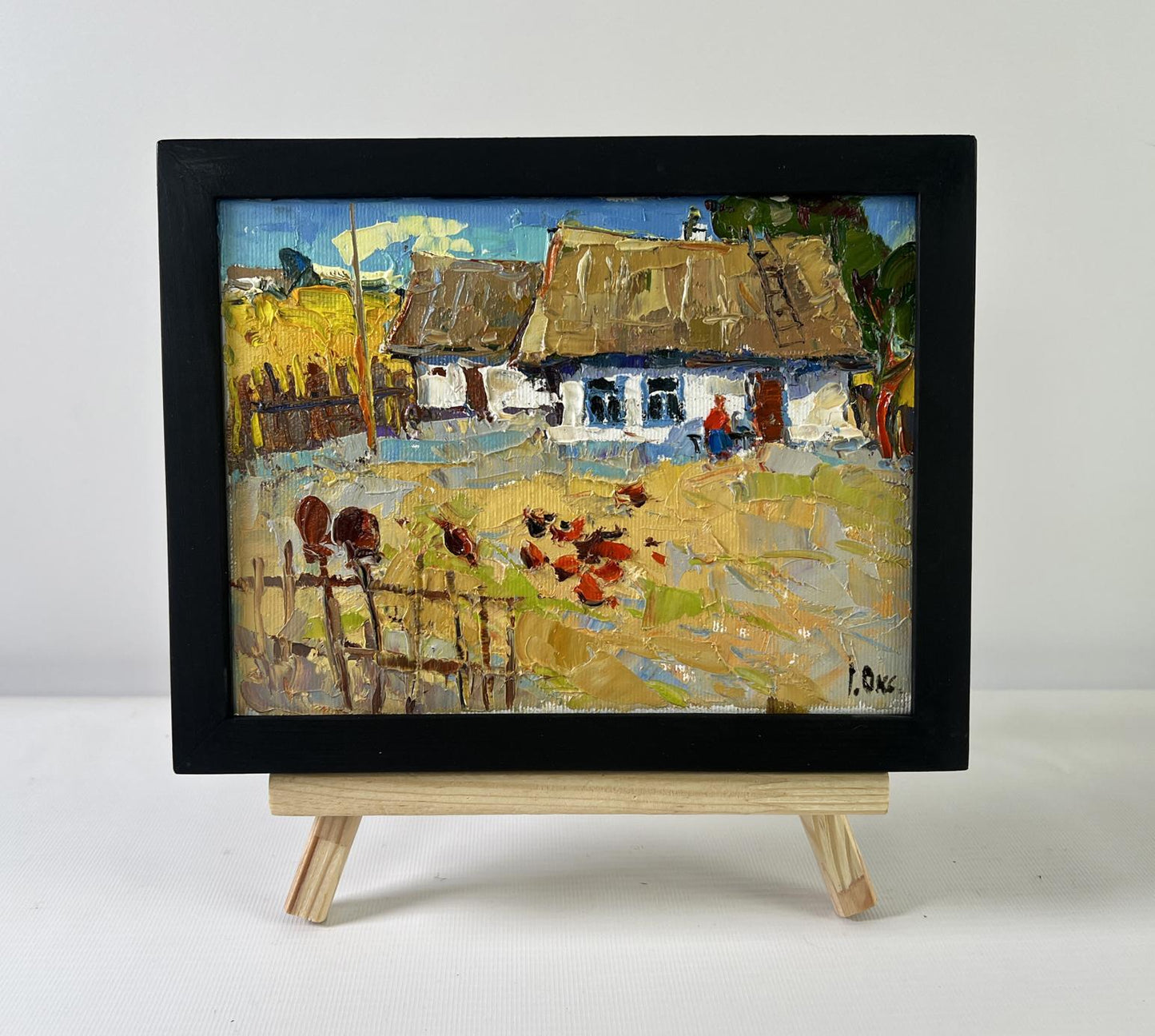 Oil painting of busy courtyard by Oksana Ivanyuk on wooden easel