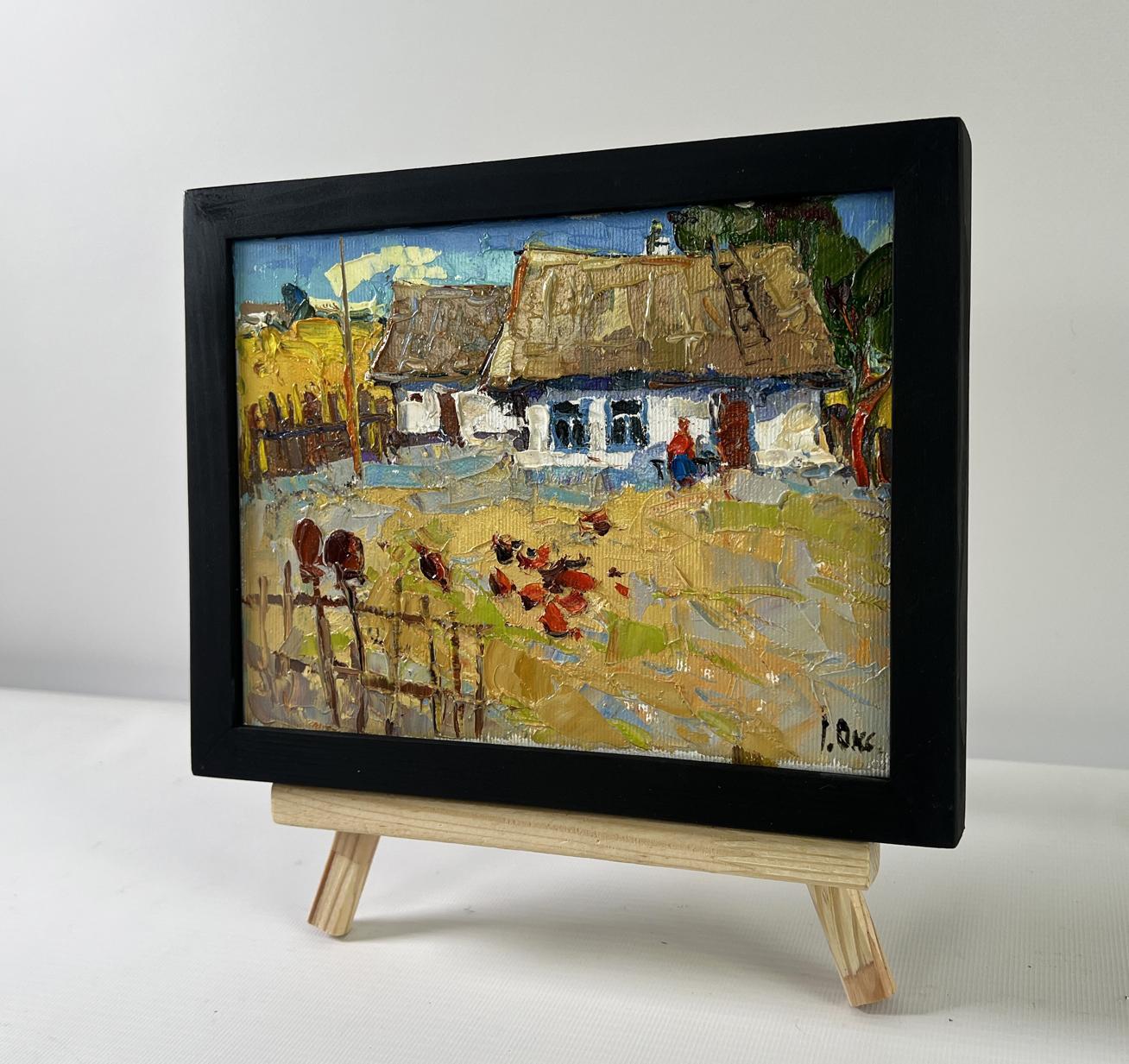 Framed oil painting by Oksana Ivanyuk of busy courtyard village scene