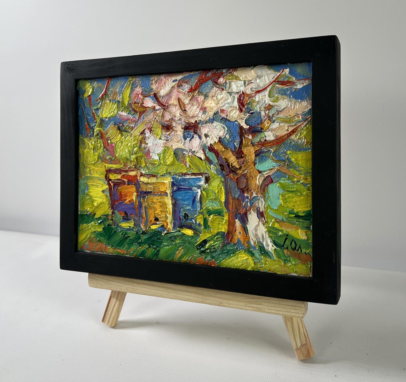 Oil painting Time for Easter by Oleksiy Ivanyuk: blossoming tree with beehives in black frame on easel