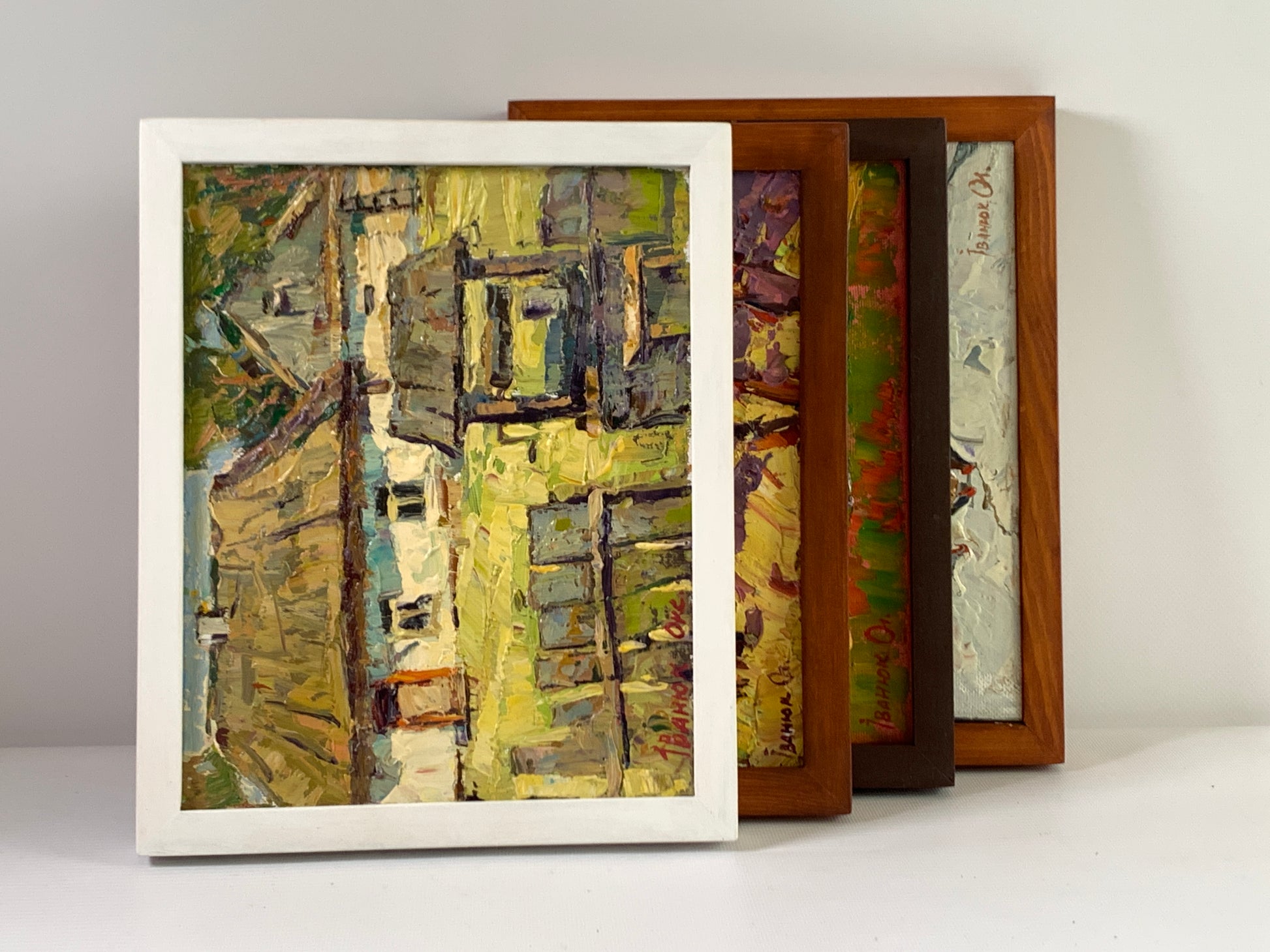 White-framed abstract painting in yellow green gray with textured brushstrokes