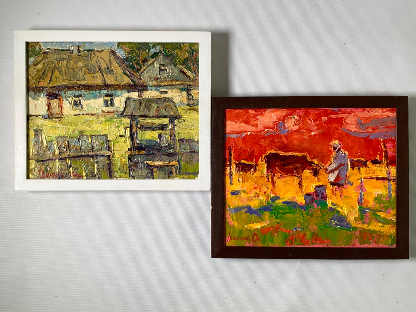 Two custom wooden frame paintings: rustic village and vibrant pastoral scenes