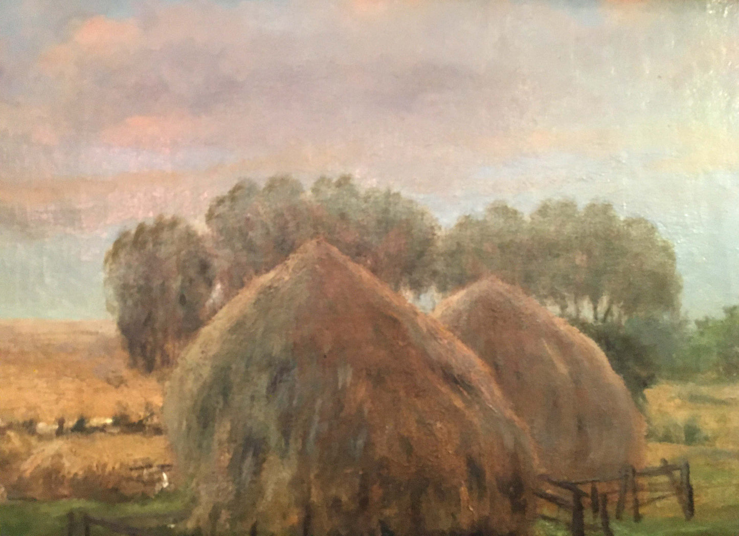 Oil painting of two golden-brown hay bales in pastoral field by Sergei Ivanovich Svetoslavsky