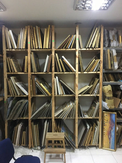 Wooden shelving units with framed artwork for wholesale paintings