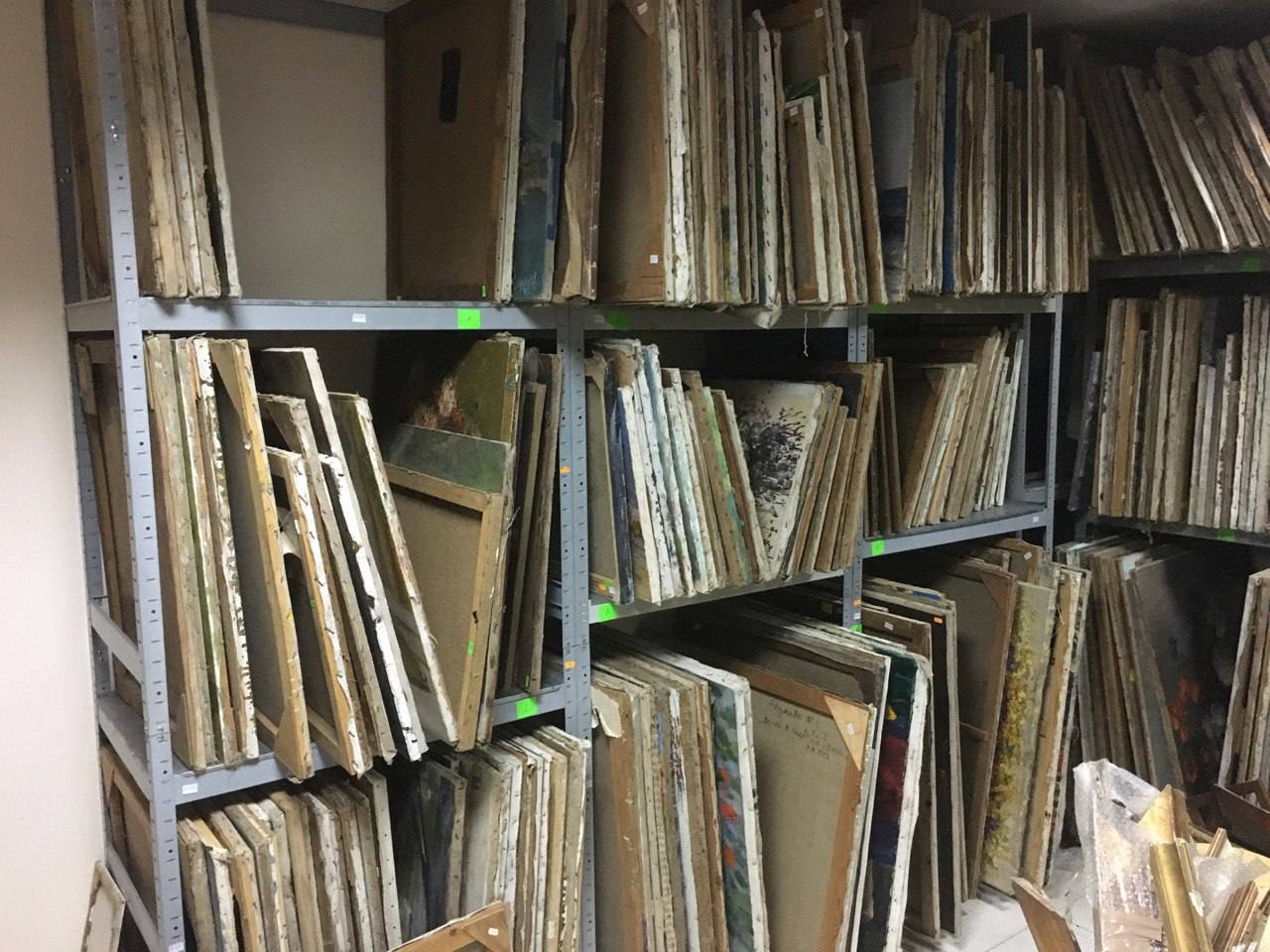 Stacks of weathered beige brown wooden canvas panels on metal shelves for wholesale paintings