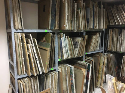 Stacks of weathered beige brown wooden canvas panels on metal shelves for wholesale paintings