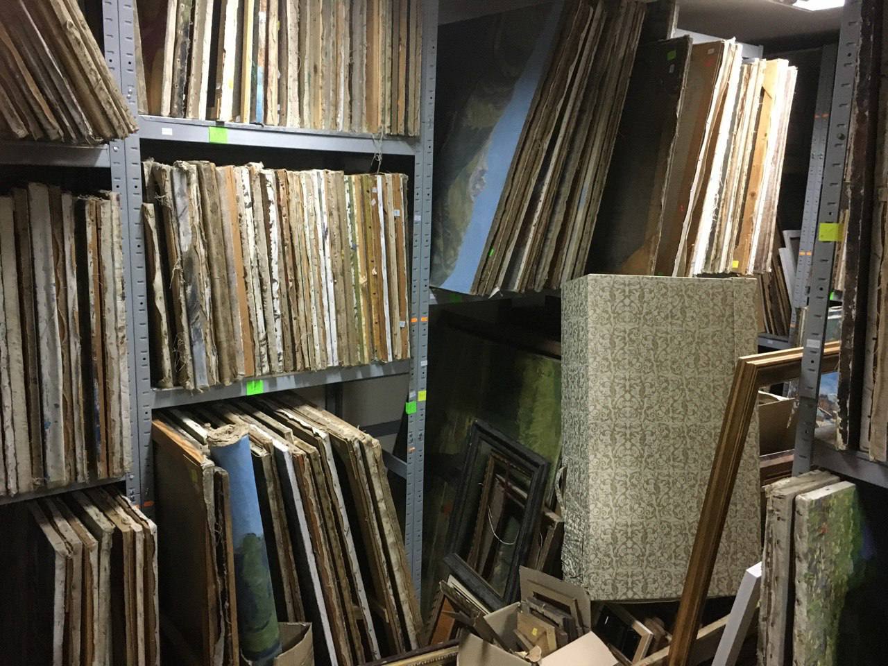 Stacks of weathered wooden picture frames on shelves for wholesale
