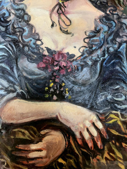 A woman in a dark blue, intricately detailed gown with voluminous ruffles and a floral embellishment at the bust.