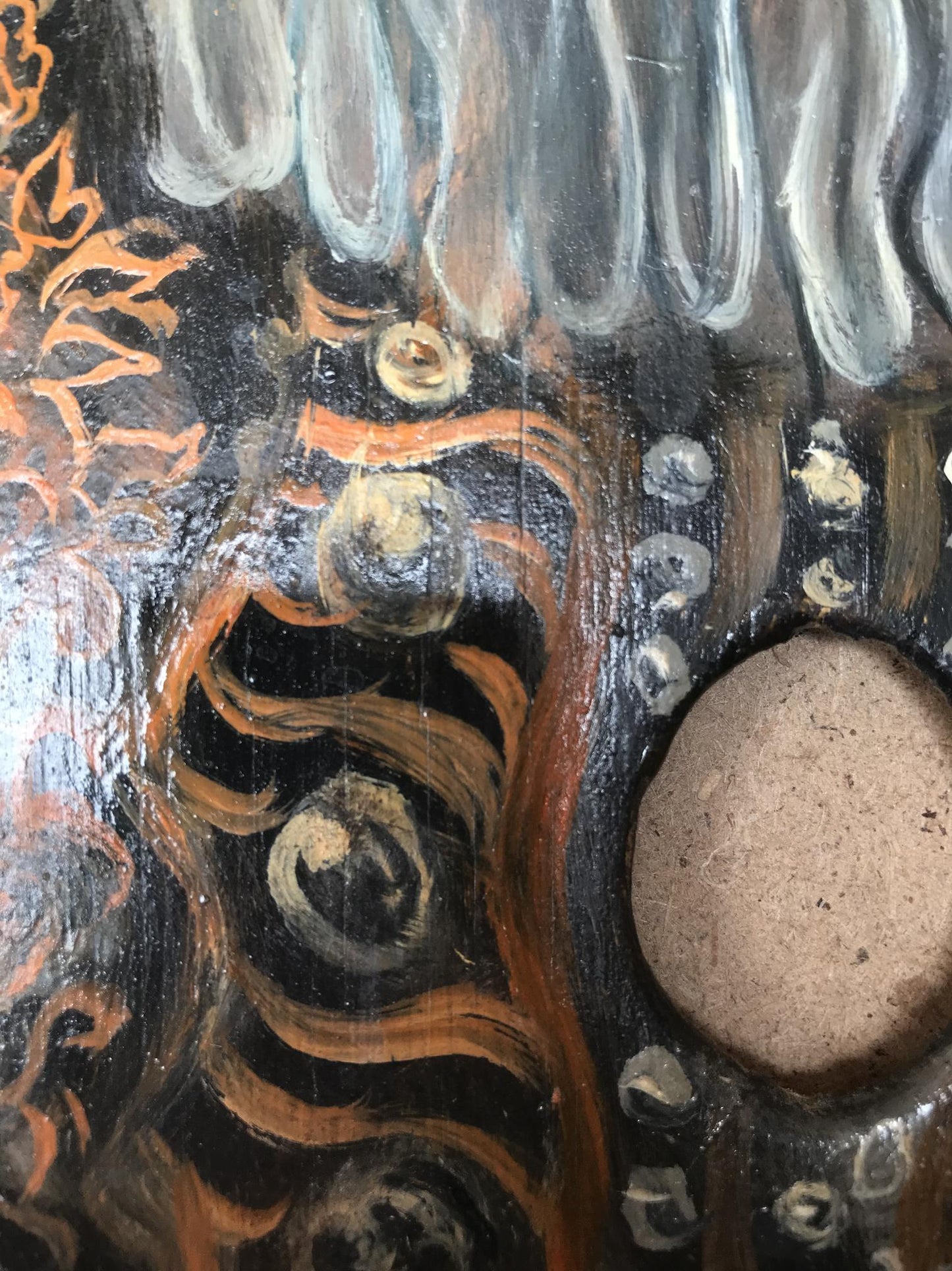 Back of oil painting portrait of Count Alexander Arkadievich Litvinov with dark hand-painted wooden surface, swirling orange and silver patterns, circular embellishments