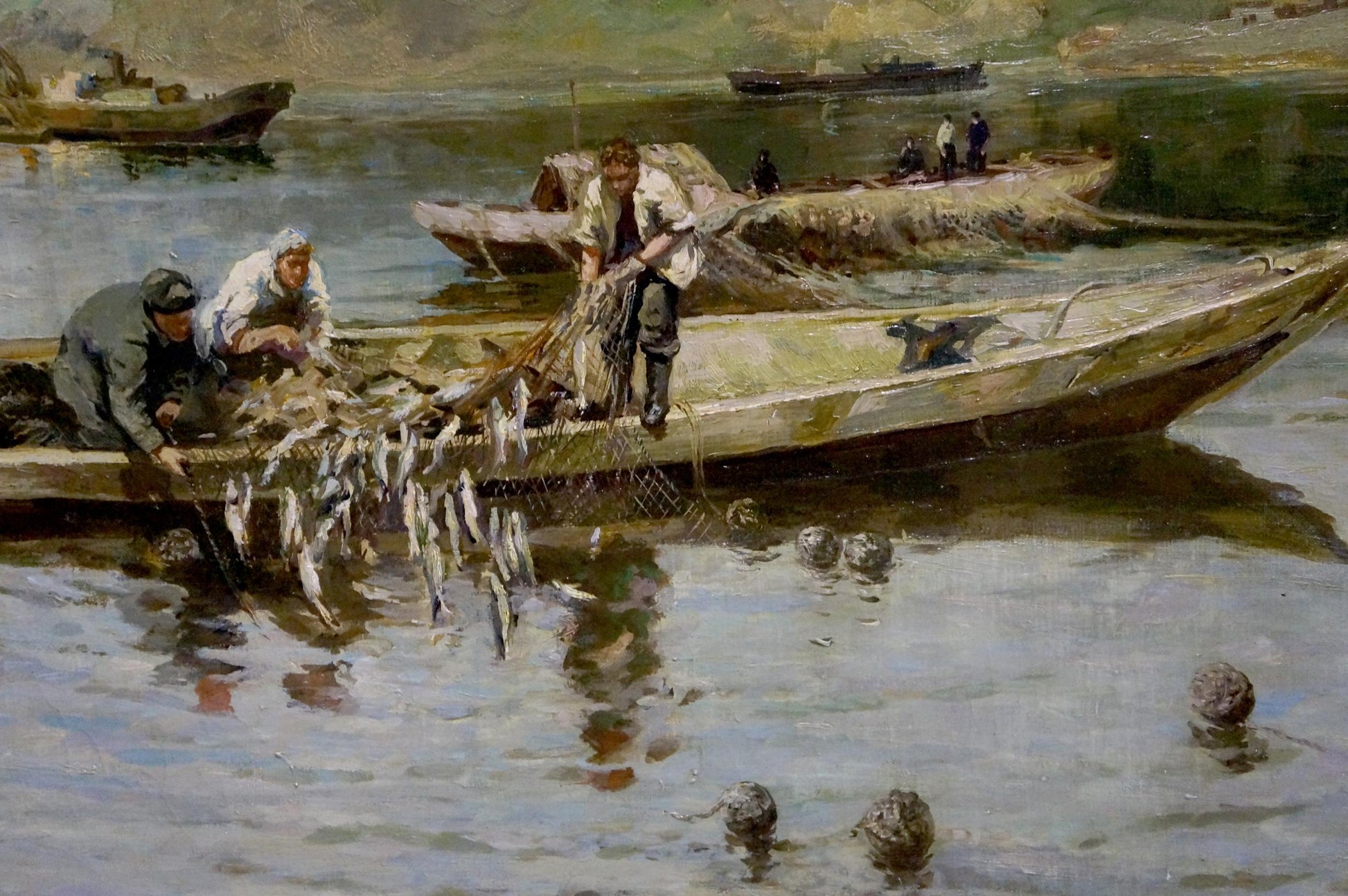 Oil painting by Muho Nikolay Antonovich: weathered green fishing boat hauling net of silver fish
