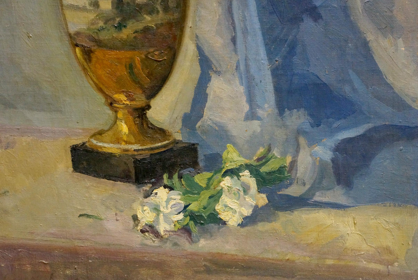 Golden ornate vase with dark base beside white flowers by Maria Glushchenko