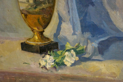 Golden ornate vase with dark base beside white flowers by Maria Glushchenko