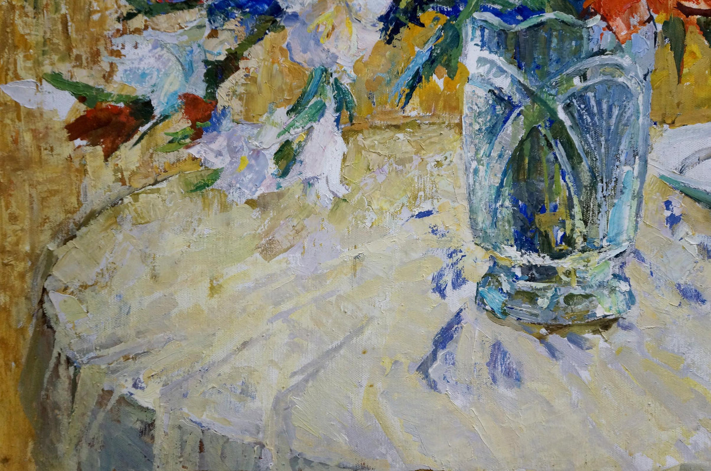 Translucent blue faceted glass vase on textured tablecloth by Mishchenko