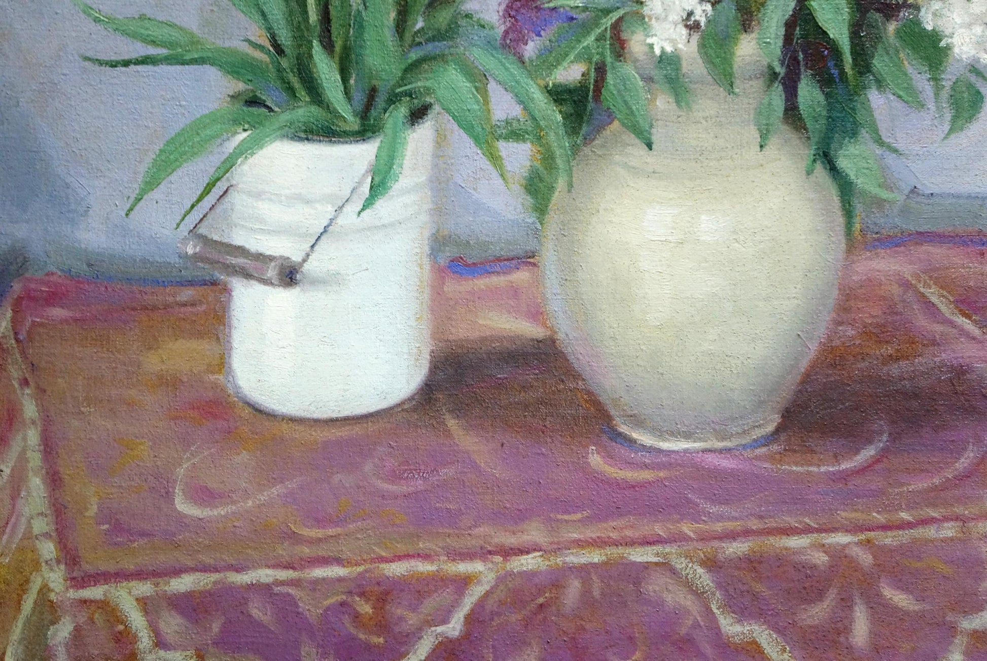 Cream-colored ceramic vase with glossy finish holding green foliage by V. Shvidchenko
