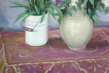 Cream-colored ceramic vase with glossy finish holding green foliage by V. Shvidchenko