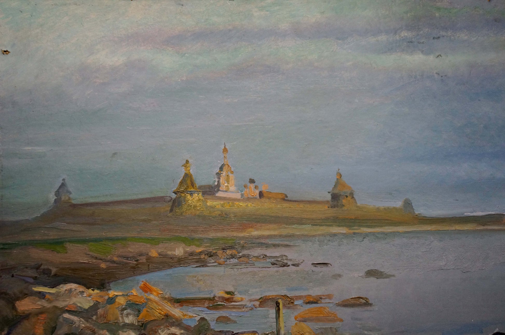Oil painting of golden-domed monastery on shore overlooking water