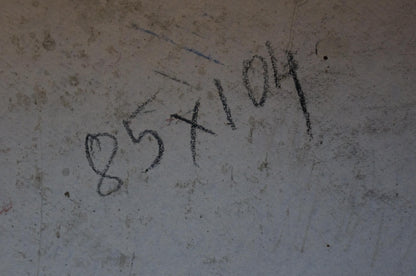 Black chalk markings on textured light gray concrete wall of oil painting