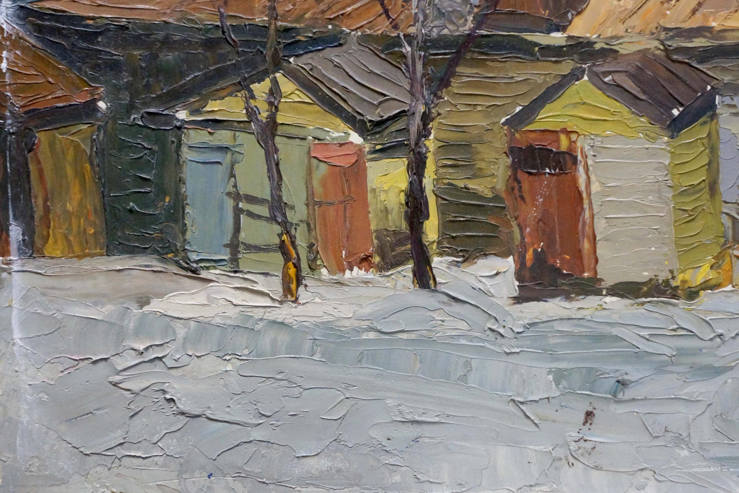 Oil painting of snowy village street with colorful wooden houses