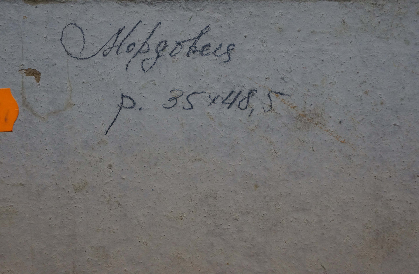Back of oil painting Haystacks by Mordovets Andrey Nikitich on gray concrete wall with inscription and orange tag