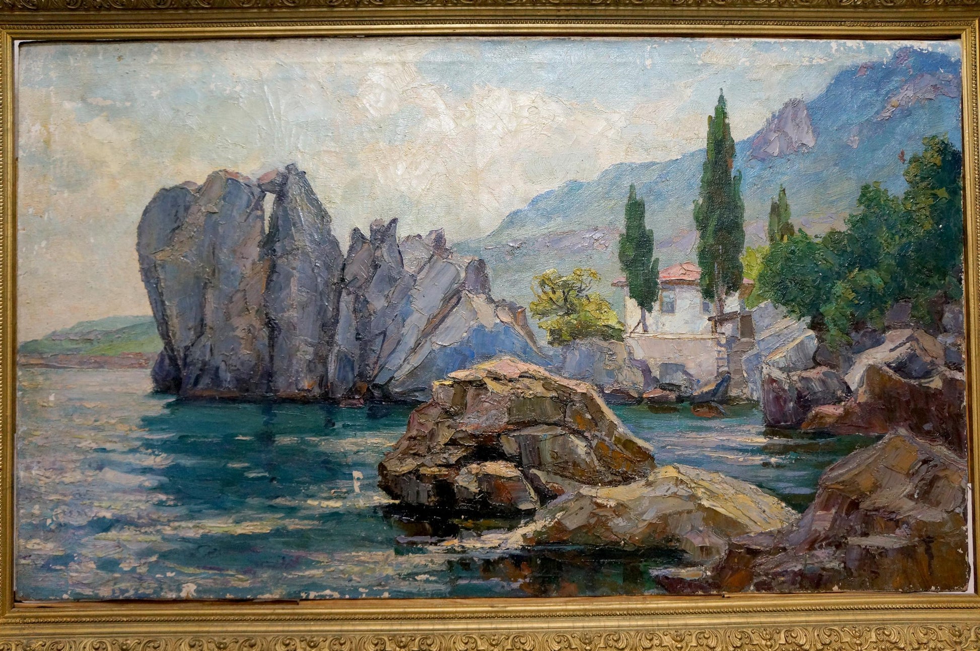Framed oil painting House by the shore with coastal rocks and turquoise water