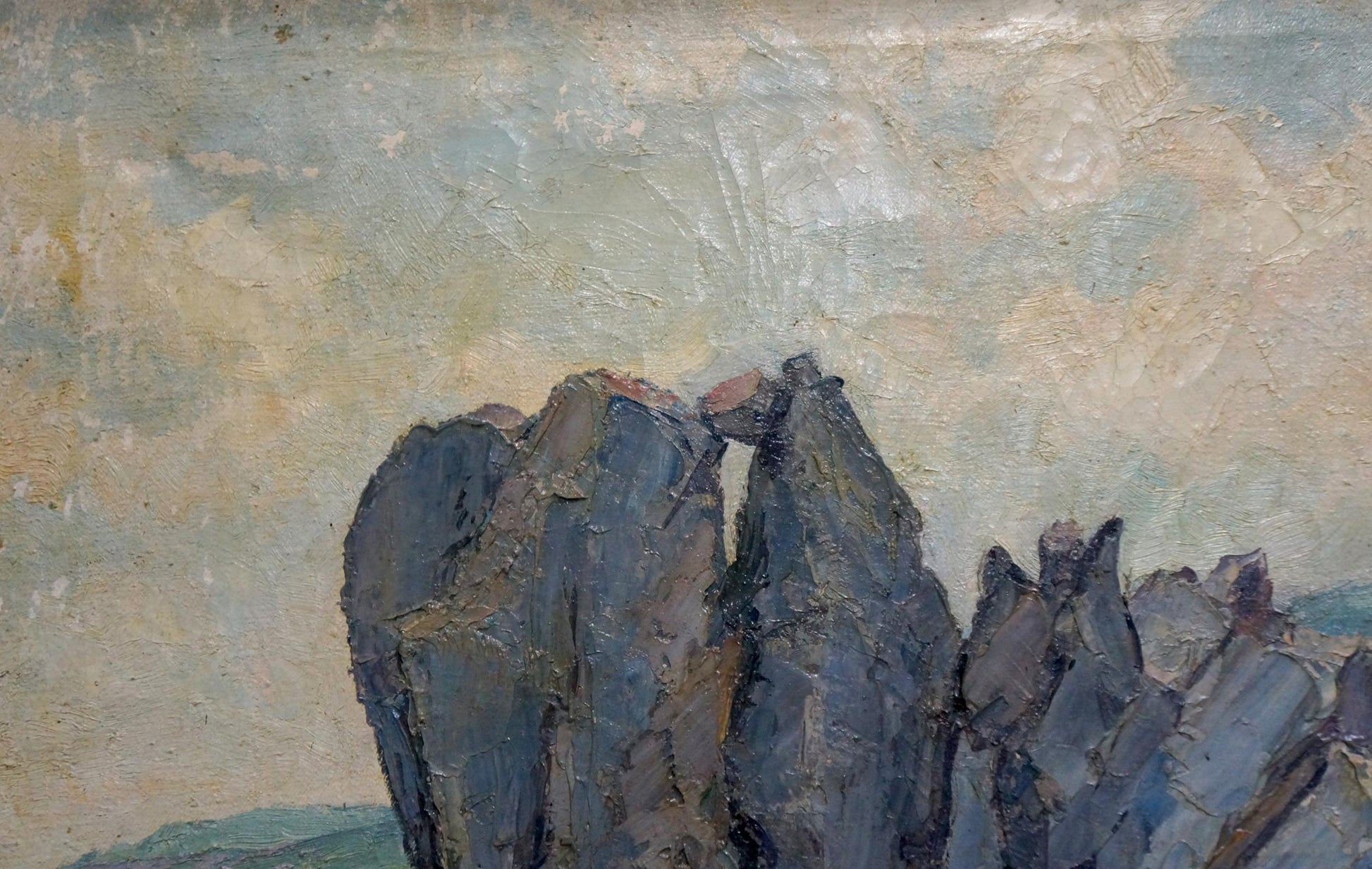 Oil painting of house by shore with rugged gray rocks and muted sky