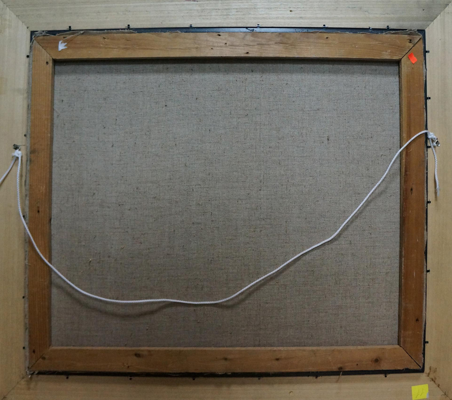 Back of Oil painting Flowers Stolyarenko Petr Kuzmich with wooden frame, gray fabric and white wire