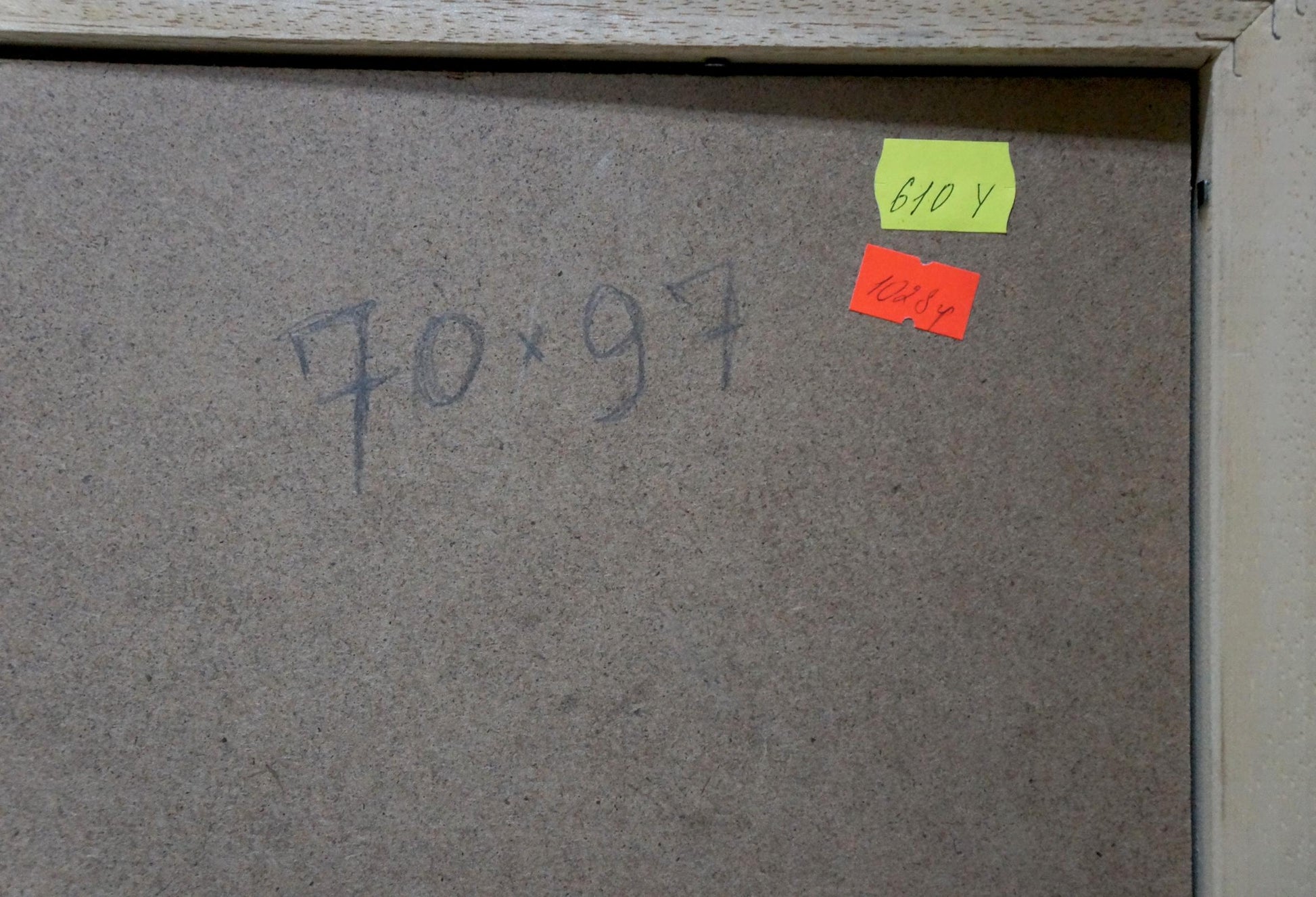 Back of oil painting portrait of female figure on gray particle board with handwritten dimensions and price tags