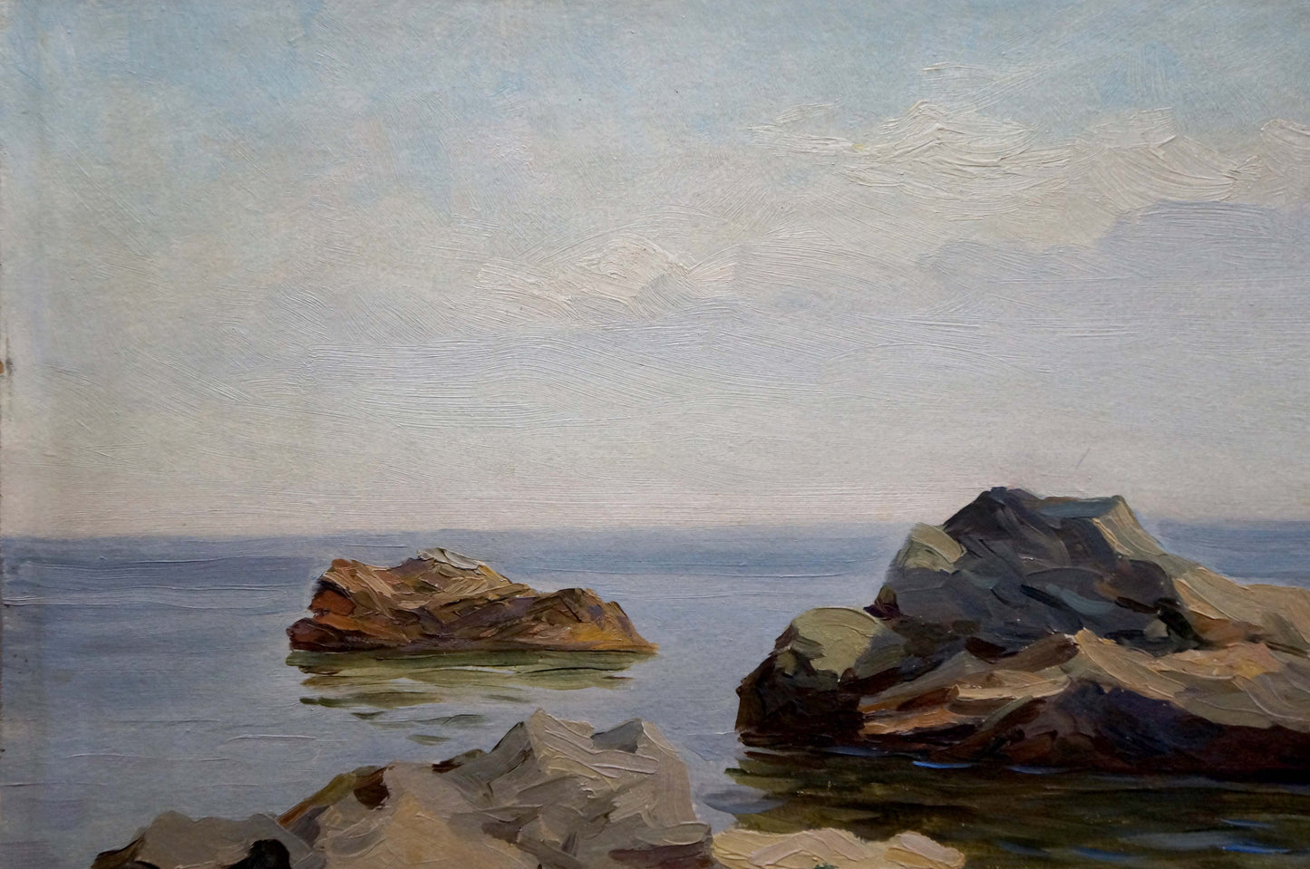 Oil painting of rugged rocks in calm sea with distant yacht by Stepan Yarovoy