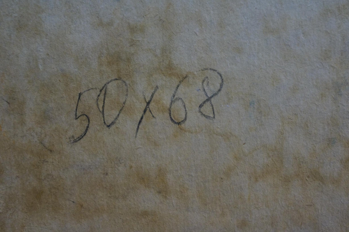 Handwritten ’50x68’’ in black ink on a textured, beige-toned surface.