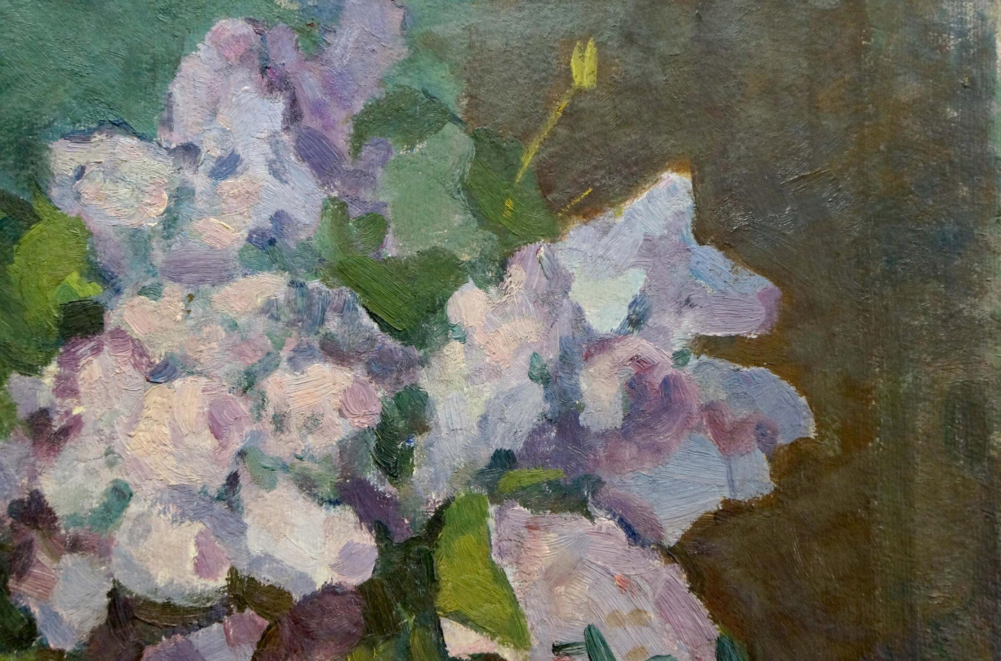 Oil painting of vase with vibrant lilac blossoms and green leaves
