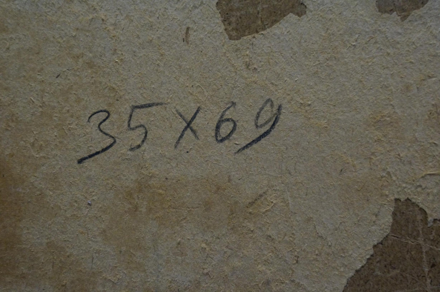 Back of Pokulity Konstantin Ivanovich oil painting with 35x69 handwritten dimensions on peeling beige wall