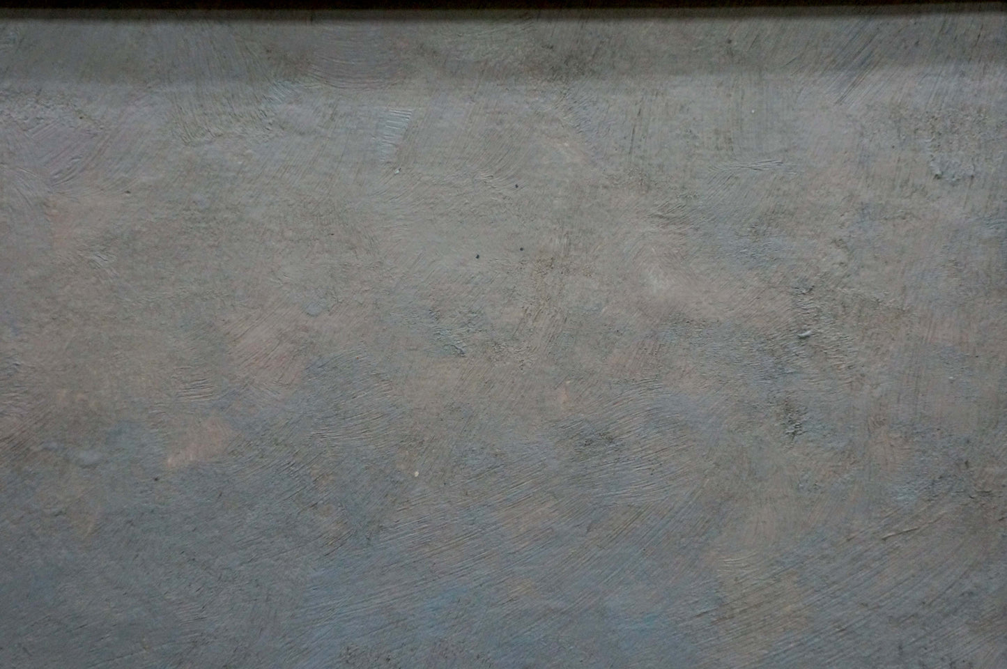 Gray textured wall behind oil painting Sunset over the sea
