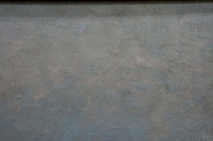 Gray textured wall behind oil painting Sunset over the sea