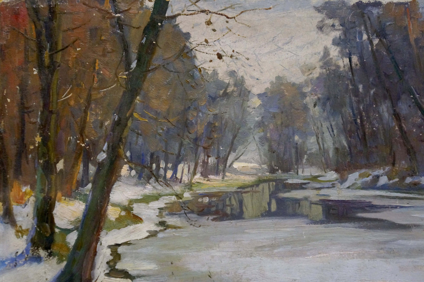 Oil painting by Egorov Boris Kuzmich: autumnal forest with bare trees on snow-dusted riverbank