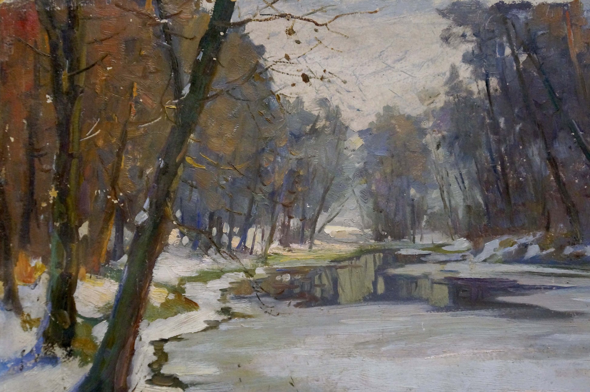 Oil painting by Egorov Boris Kuzmich: autumnal forest with bare trees on snow-dusted riverbank