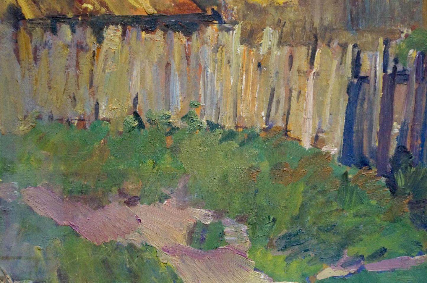A textured, impressionistic painting of a wooden fence with vertical strokes in warm yellows and browns, set against lush green foliage.