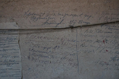Back of oil painting The table is set by Sakhnenko Victor Ivanovich with thin metallic wire on Cyrillic script wall