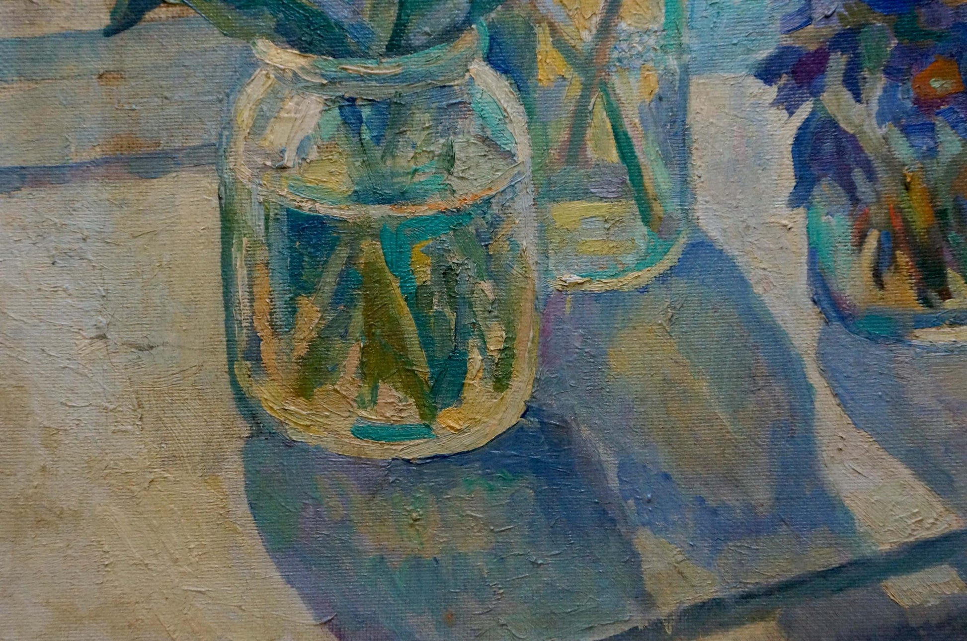 Clear textured glass jar with green poppy stems in water by Nechiporenko Elena Henrikhovna