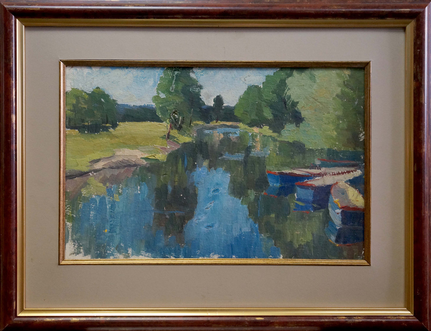 Framed impressionist oil painting of trees along serene river with boats