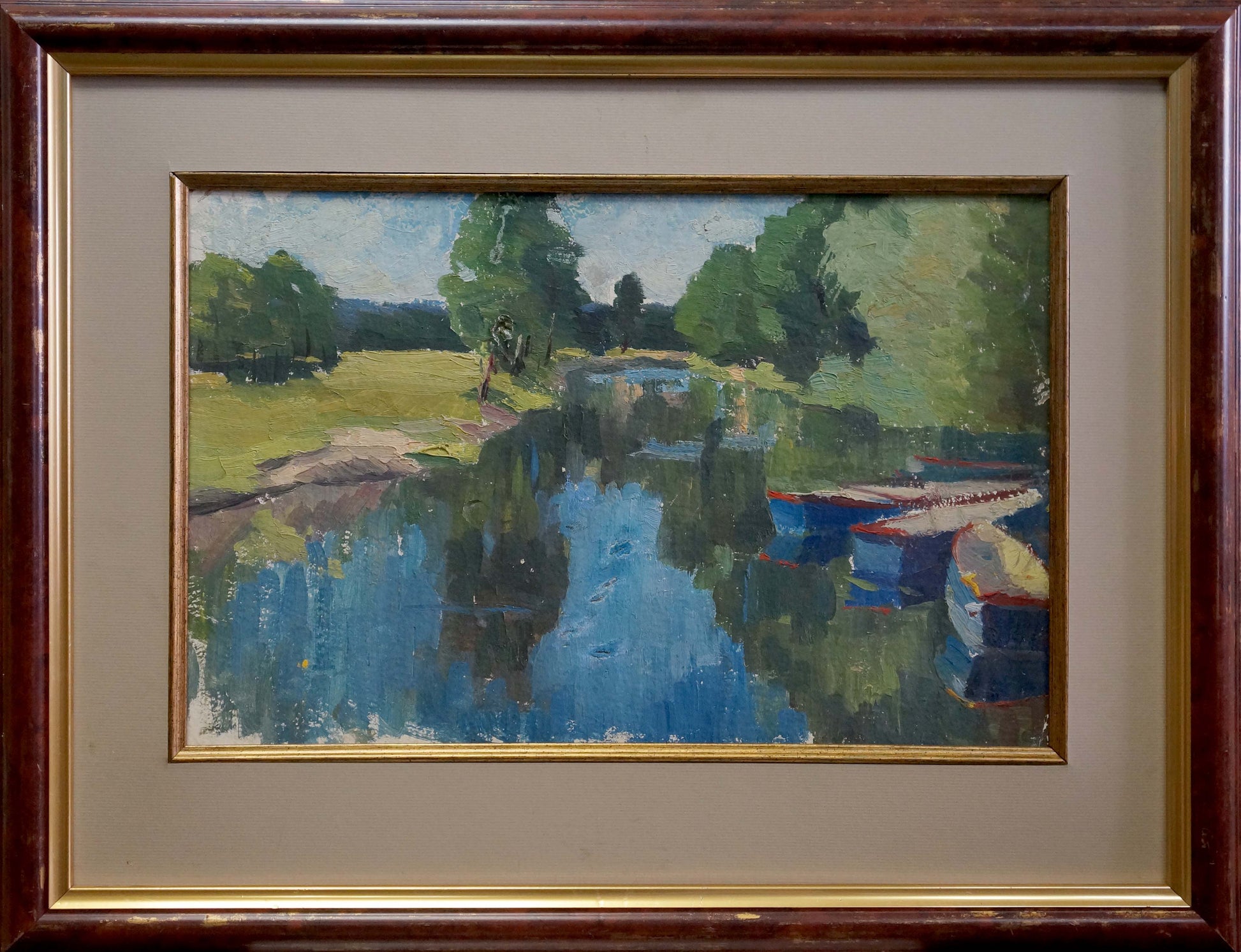 Framed impressionist oil painting of trees along serene river with boats