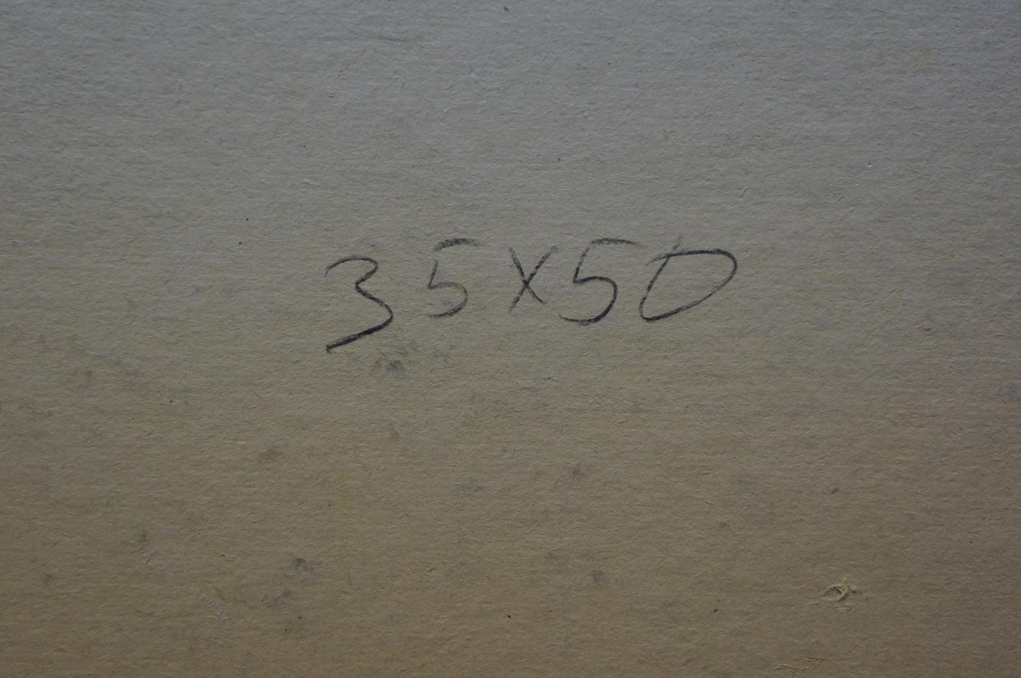 Handwritten ’35x50’’ in black ink on a textured, beige-colored surface.