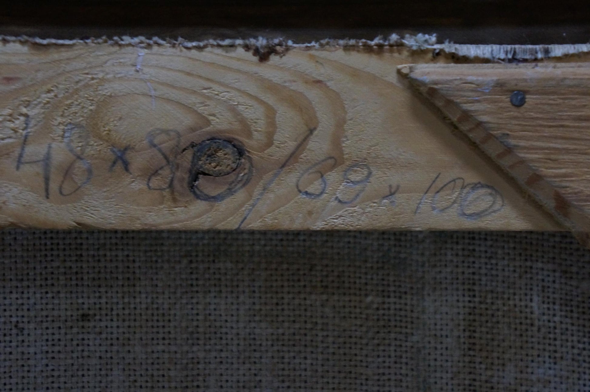 Back of Oil painting Raging sea: light brown plank with grain, knot, black ink measurements
