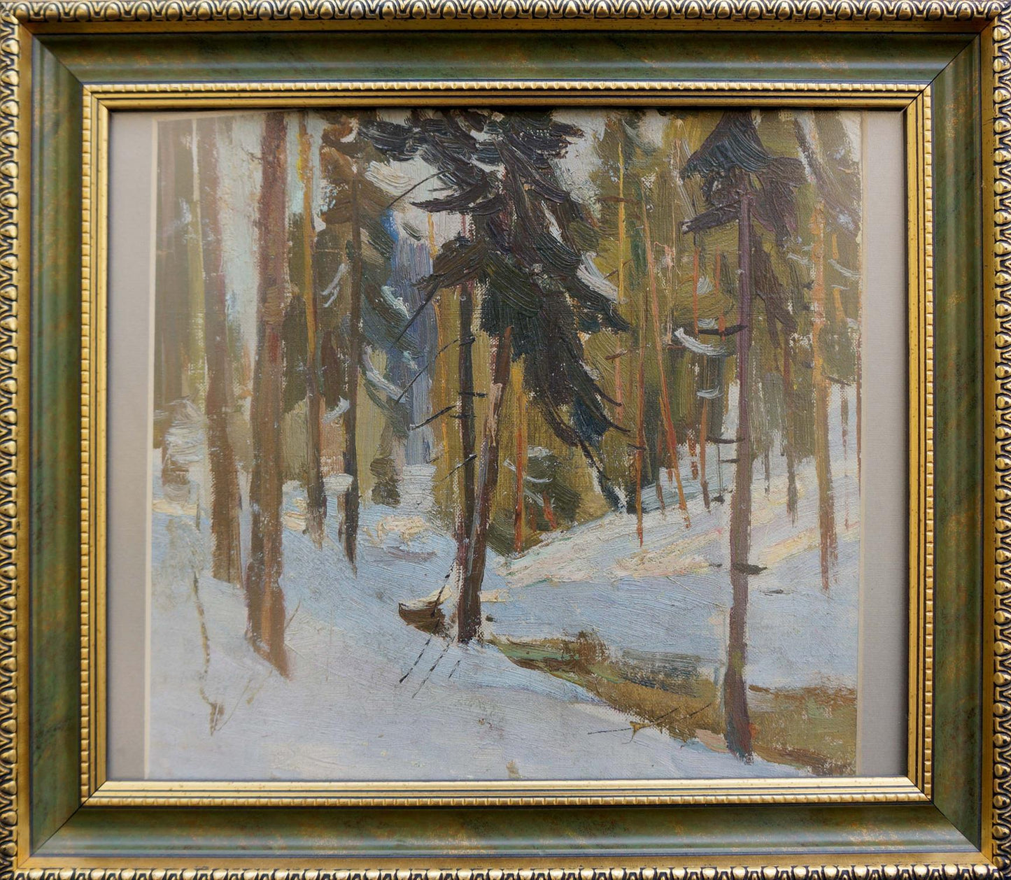 Oil painting of snowy forest landscape in ornate gold green frame