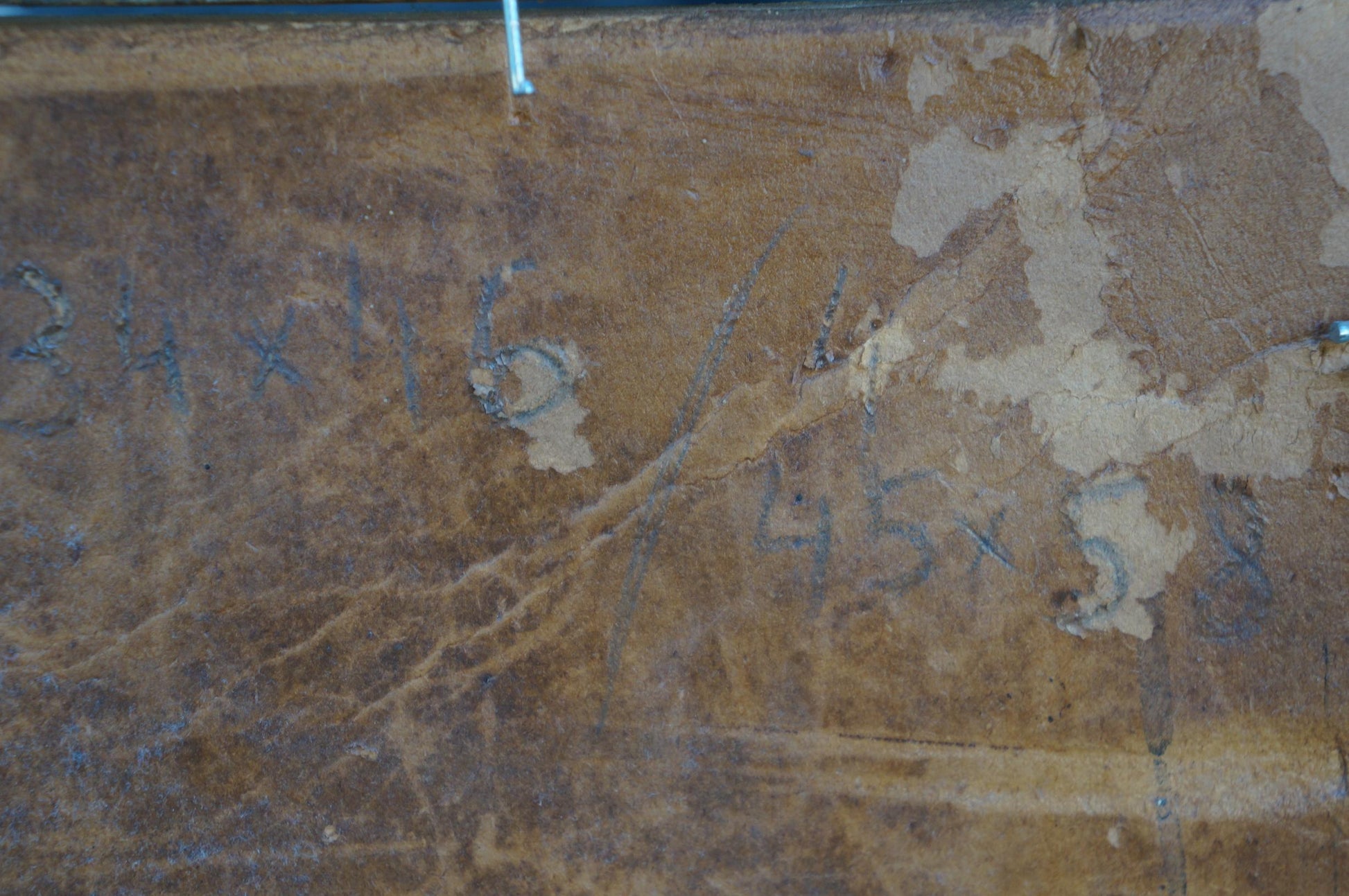 Back of Oil painting Swamps: weathered brown wood with peeling paint, faded blue markings