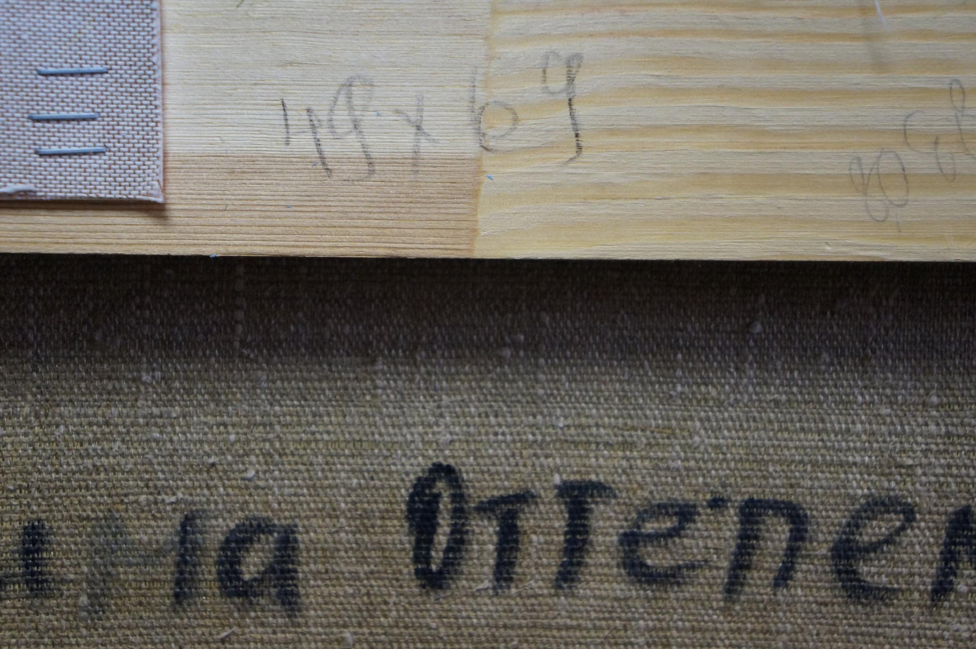 Close-up of textured beige canvas with black lettering on Winter Kogan Boris Matveevich oil painting
